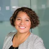 Maria, a department head with curly hair in a bright office