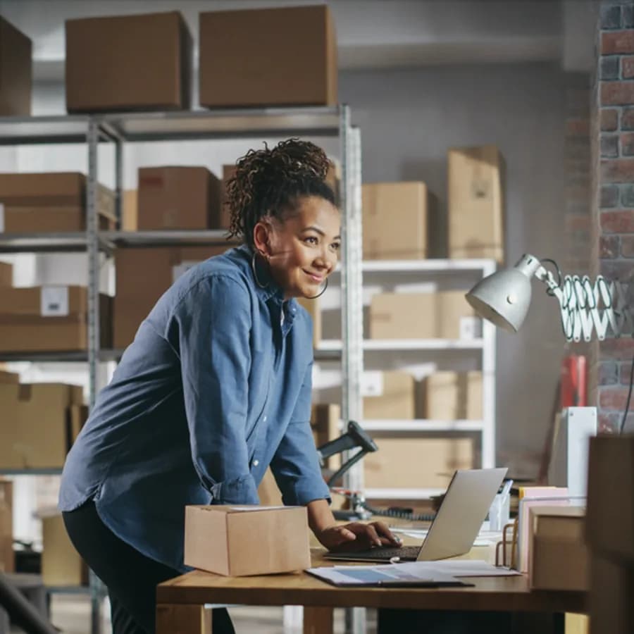 Warehouse manager using Zahara on a laptop to manage purchase orders and approvals