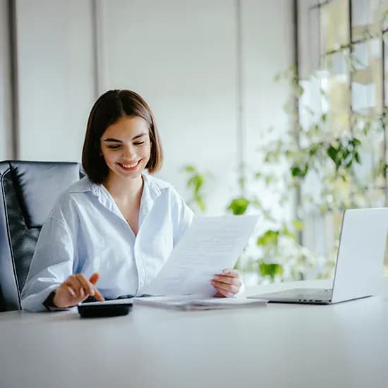 Care provider finance administrator reviewing supplier invoice documents
