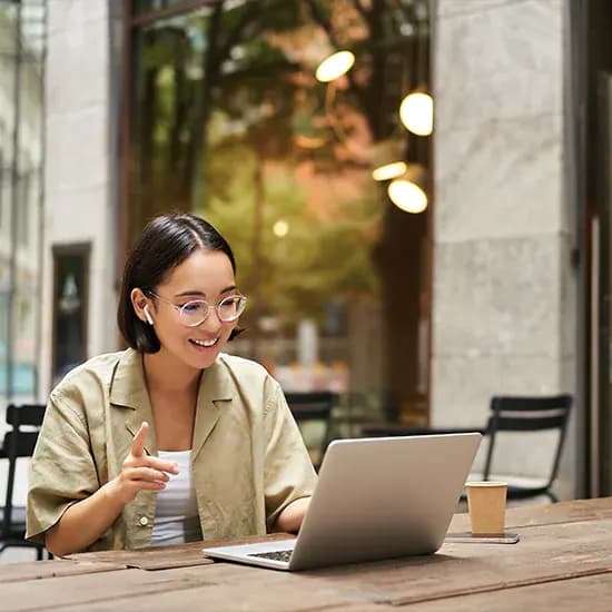 Education finance administrator reviewing spend reporting on a laptop
