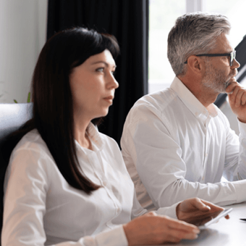 A business team discussing purchase approvals on a digital dashboard in Business Central
