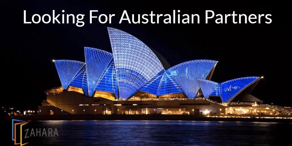 Image of the Sydney Opera House illuminated at night with blue lights, featuring a "Looking For Australian Partners" headline and a "Zahara" logo in the bottom left corner. This stunning visual captures the essence of Australia and its vibrant opportunities.